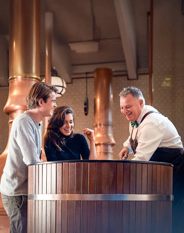 Heineken Experience guide demonstrating beer pouring in Amsterdam.