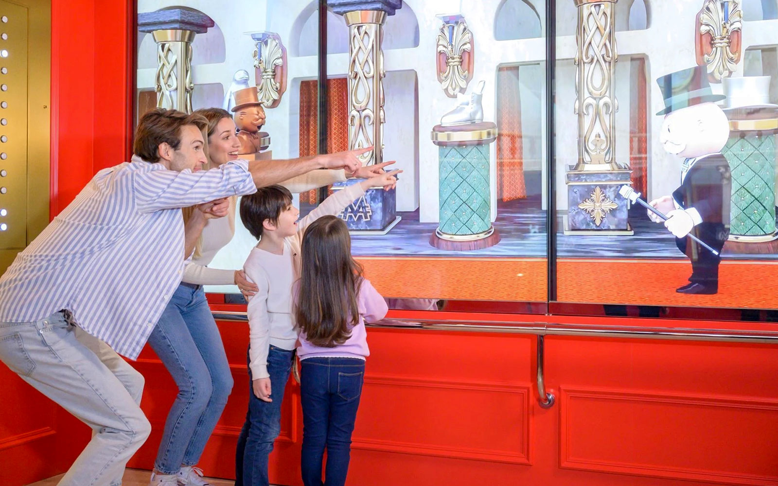 Family enjoying interactive display at Monopoly Dreams Melbourne.