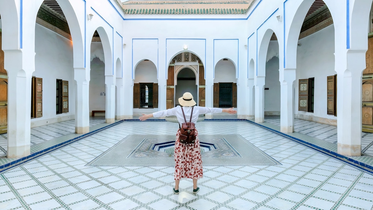 Person standing in courtyard of Bahia Palace, Marrakech, Morocco.