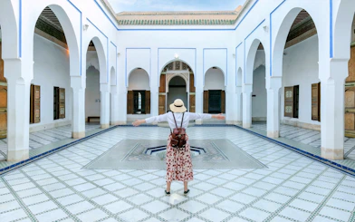 Person standing in courtyard of Bahia Palace, Marrakech, Morocco.