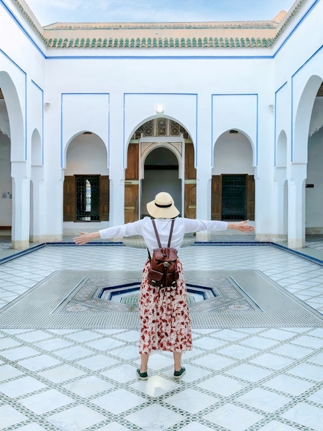 Person standing in courtyard of Bahia Palace, Marrakech, Morocco.