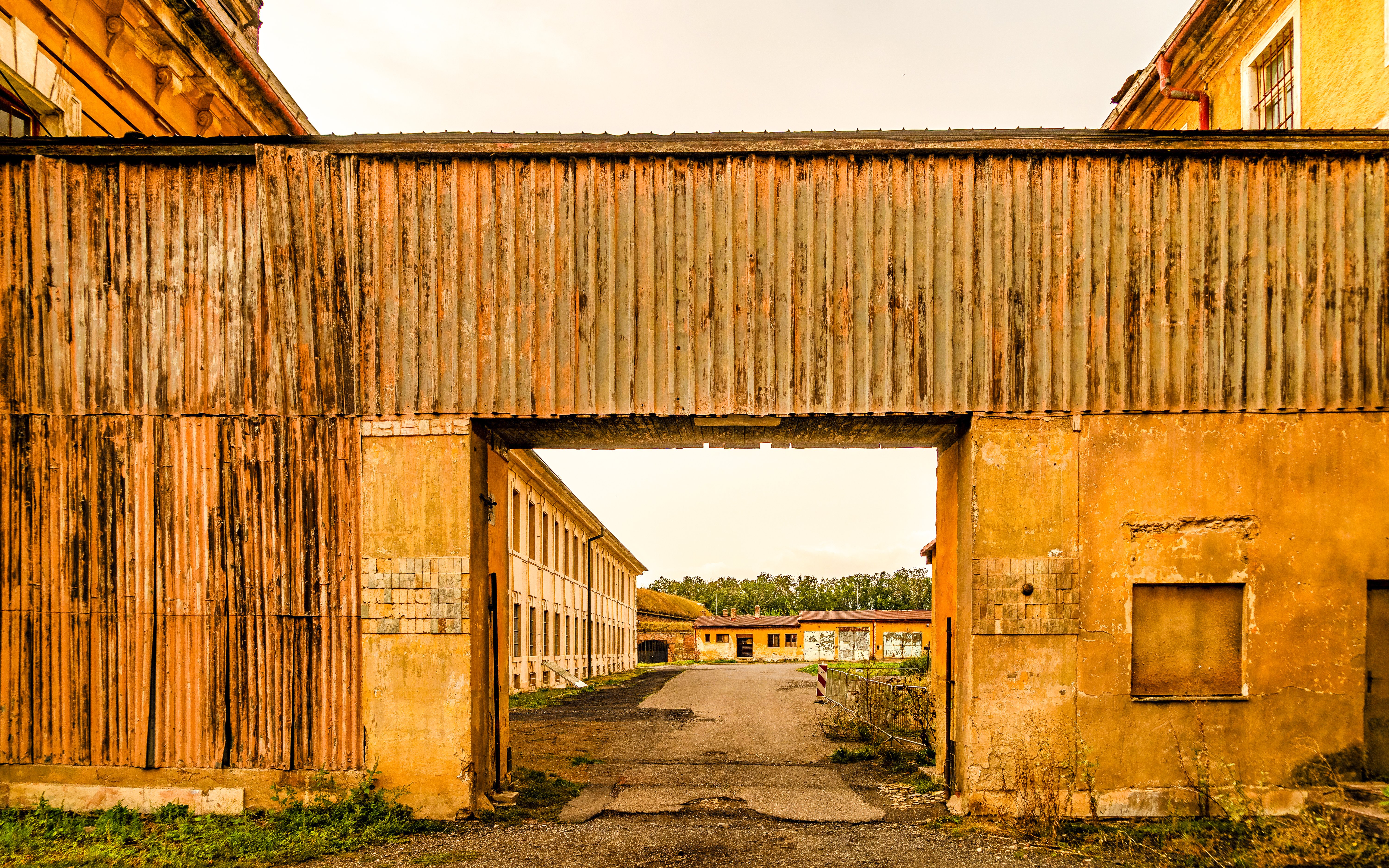 Entrance to Terezín Concentration Camp with historic buildings and courtyard.