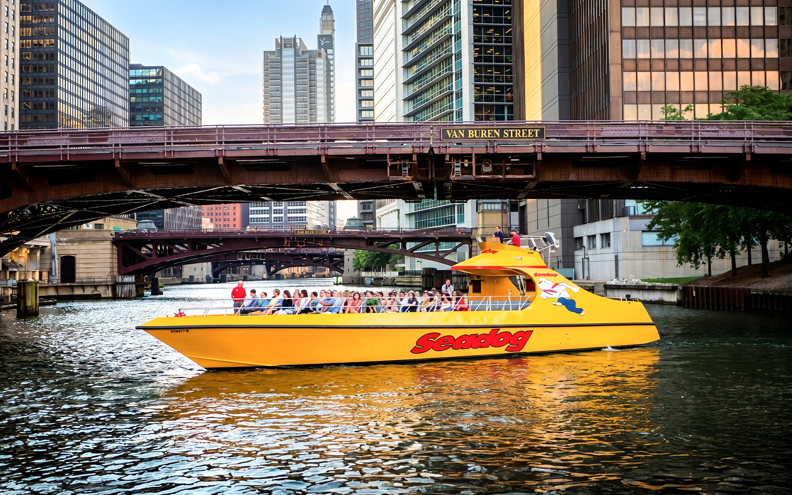 Seadog cruise boat on Chicago River under Van Buren Street bridge, Lake Michigan tour.