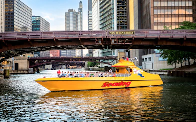 Seadog cruise boat on Chicago River under Van Buren Street bridge, Lake Michigan tour.