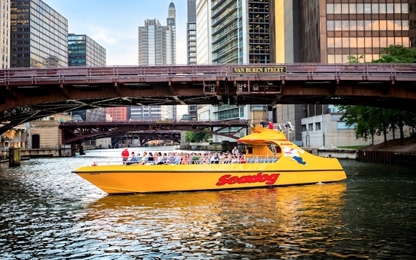 Seadog cruise boat on Chicago River under Van Buren Street bridge, Lake Michigan tour.