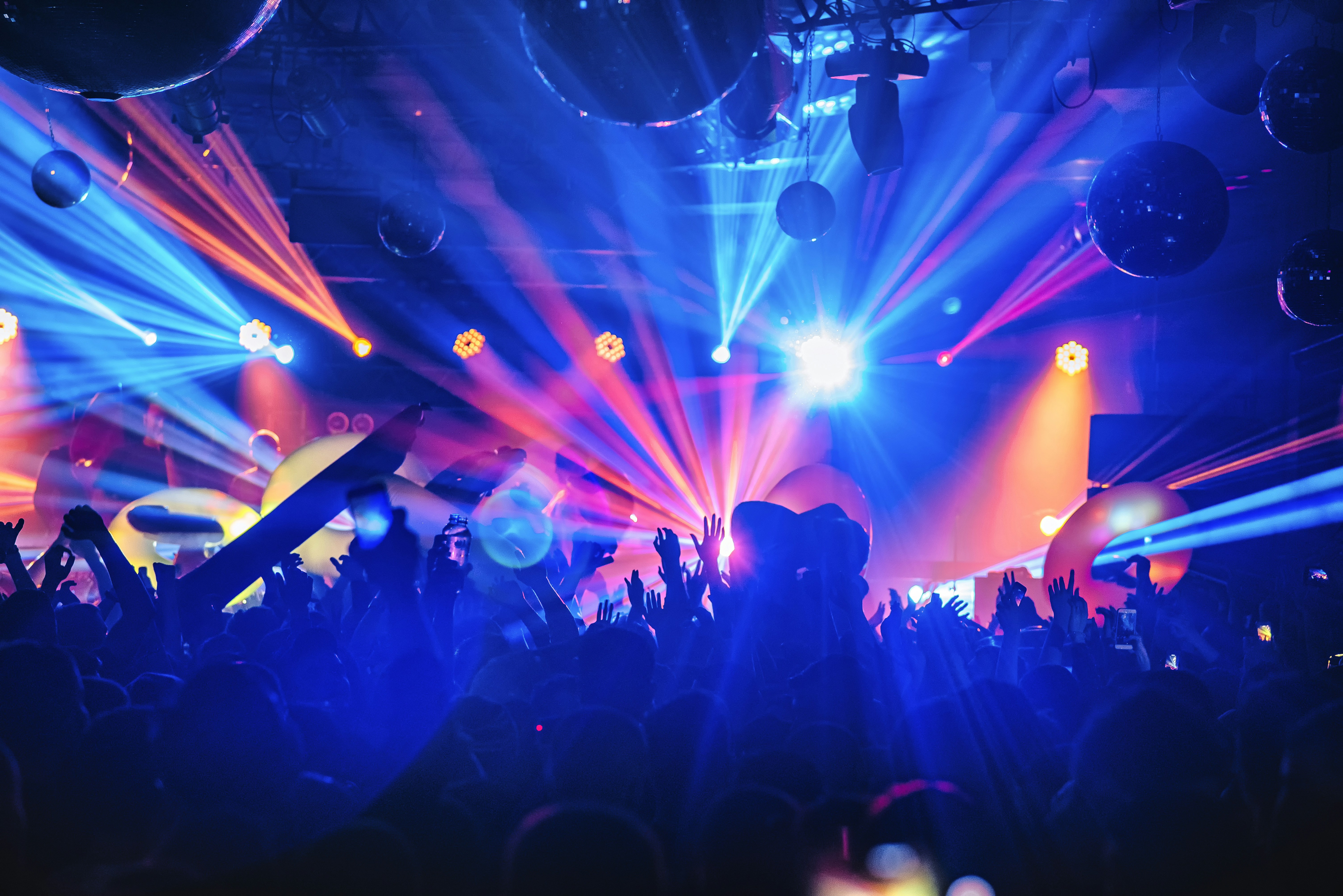 People dancing in blue lights at UNVRS