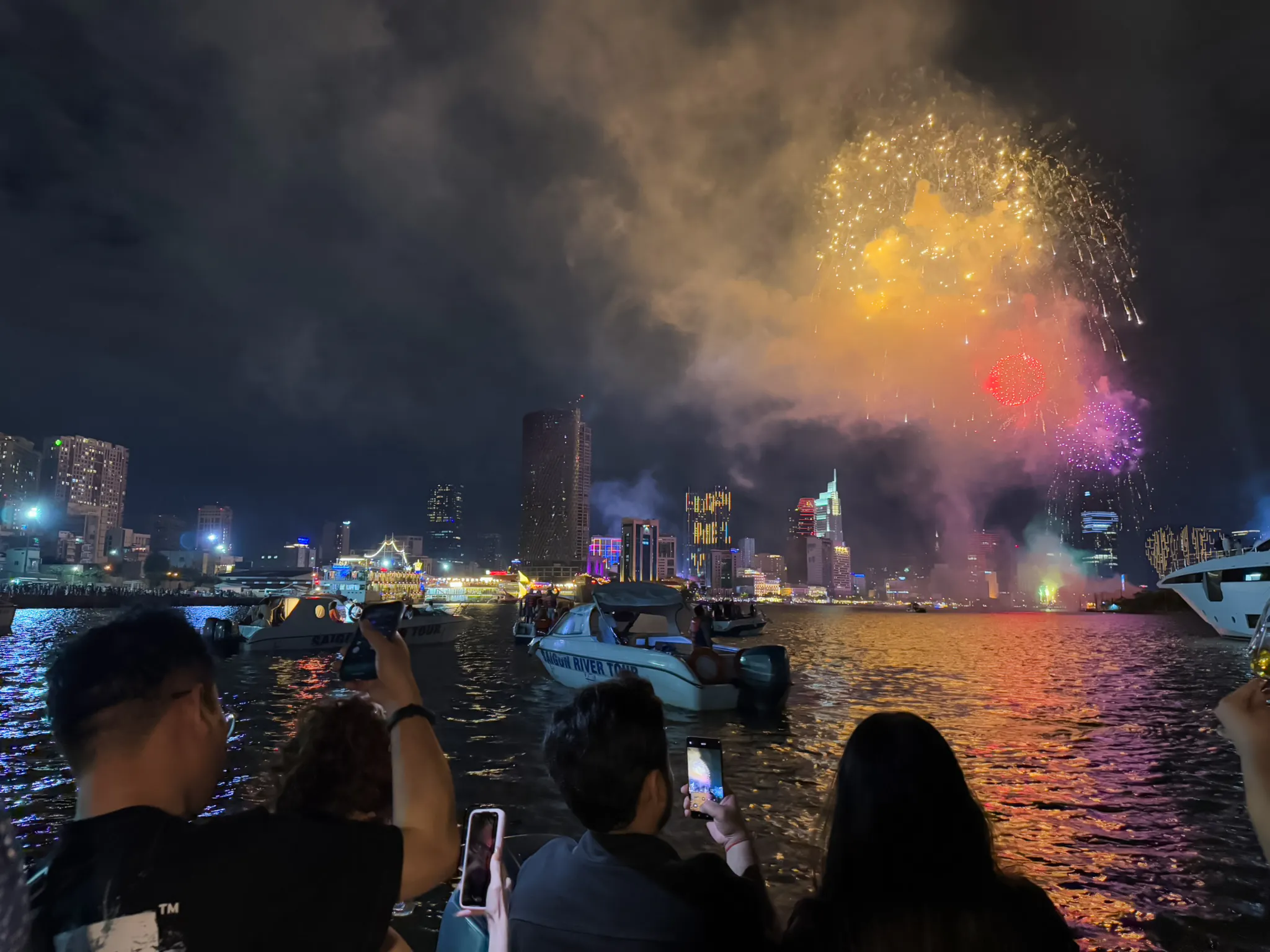 Fireworks over Ho Chi Minh City skyline during New Year’s Eve cruise on Saigon River.