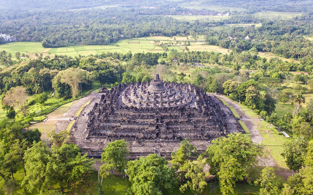 Borobudur Temple aerial view surrounded by lush greenery, Java, Indonesia.