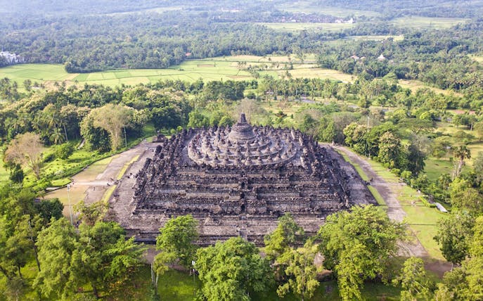 Borobudur Temple aerial view surrounded by lush greenery, Java, Indonesia.