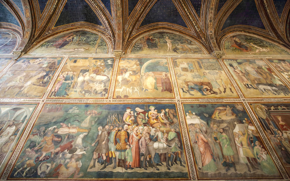 Frescoes inside Siena Cathedral depicting historical and religious scenes, Italy.
