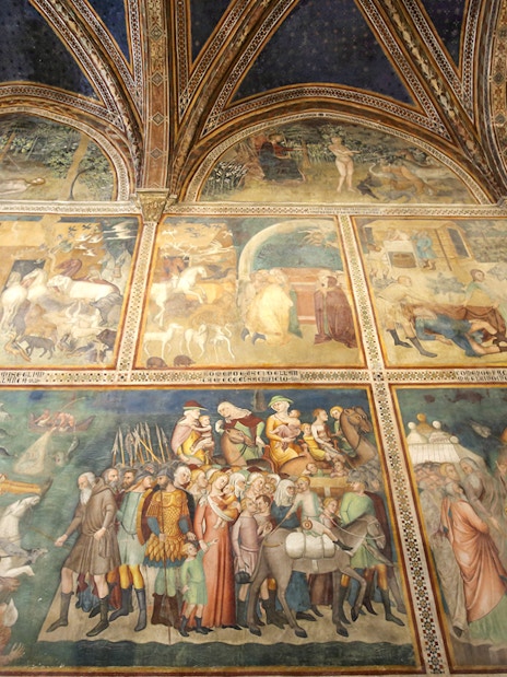 Frescoes inside Siena Cathedral depicting historical and religious scenes, Italy.