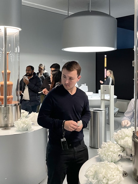 Visitors exploring chocolate fountains at Lindt Home of Chocolate Museum in Zurich.