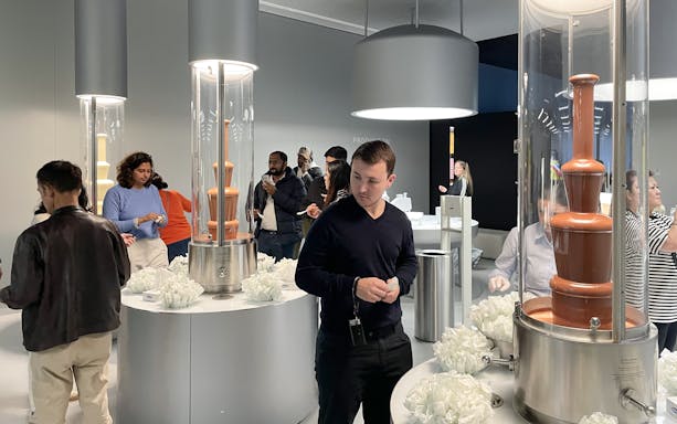 Visitors exploring chocolate fountains at Lindt Home of Chocolate Museum in Zurich.