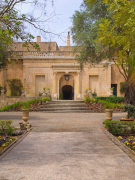 Entrance to San Anton Botanical Gardens, Malta, with stone steps and lush greenery.