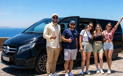 Tourists posing by a private car with ocean view in Tangier.