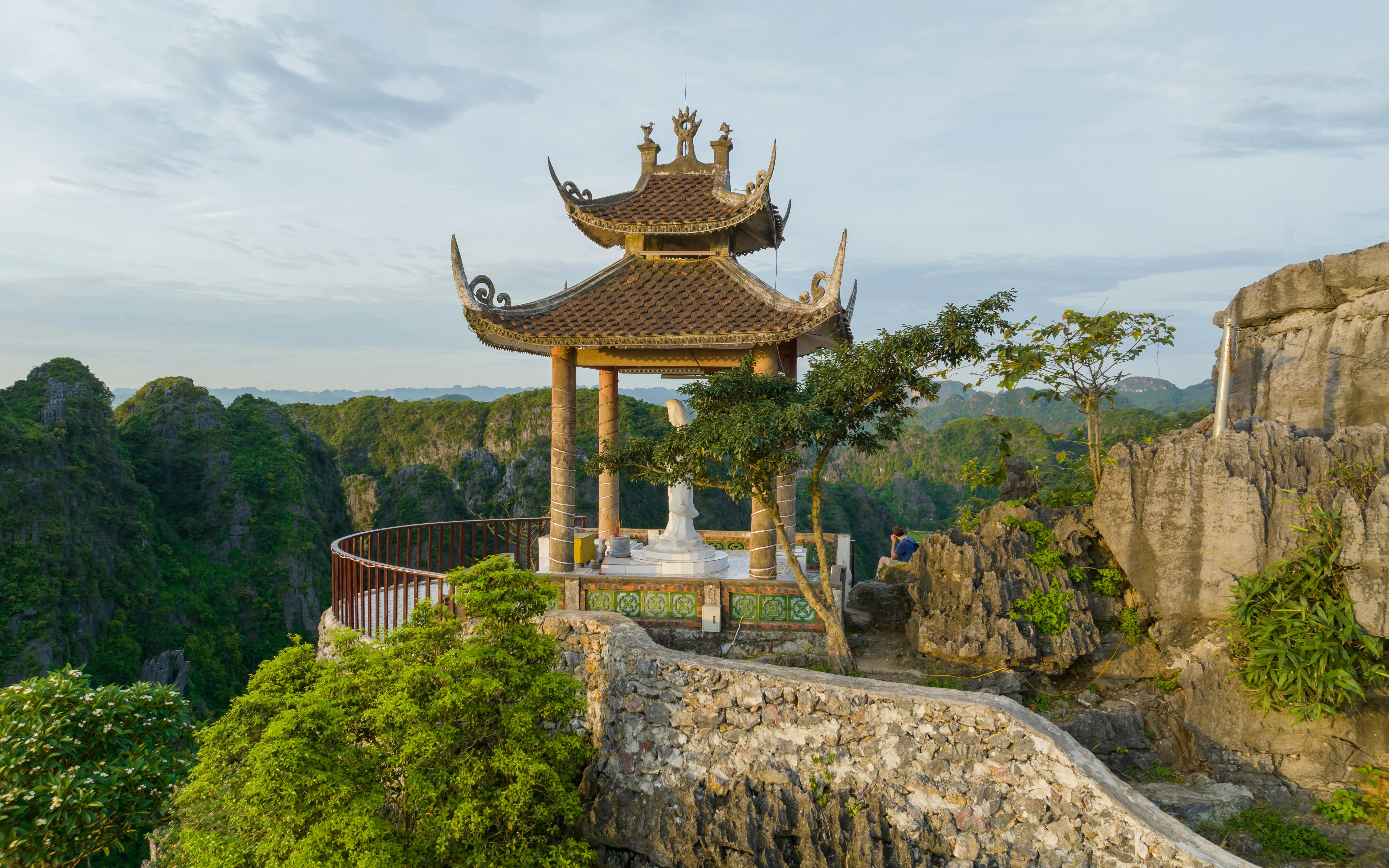 Pagoda at Mua Cave overlooking lush green mountains in Ninh Binh, Vietnam.