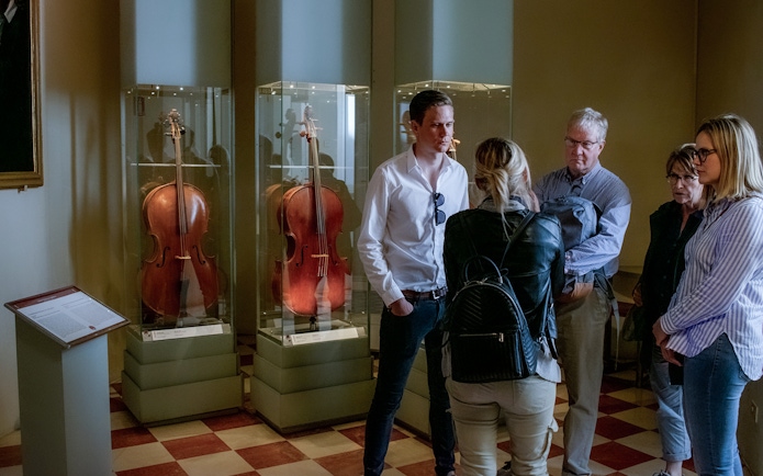 Tour guide speaking to a group in the Musical Instruments room, Accademia Gallery.