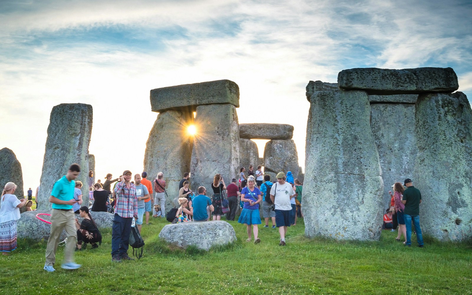 Tourists walking among Stonehenge stones on a unique day trip from London.