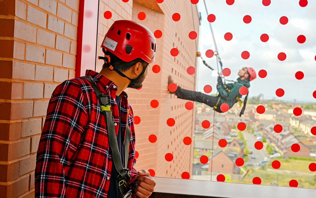 Guest observing abseiler at Anfield Abseil Experience, Liverpool.