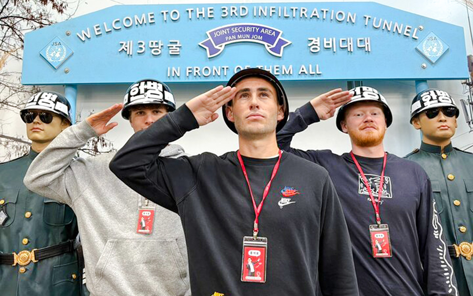 Tourists saluting with soldier mannequins at the 3rd Infiltration Tunnel entrance, DMZ, South Korea.