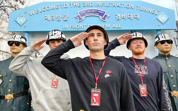 Tourists saluting with soldier mannequins at the 3rd Infiltration Tunnel entrance, DMZ, South Korea.