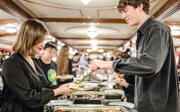 Buffet dining on Budapest Danube River evening cruise with live music.
