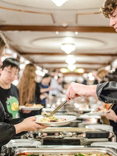 Buffet dining on Budapest Danube River evening cruise with live music.