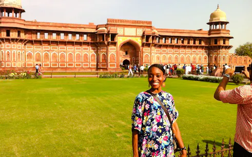 Visitor at Agra Fort with red sandstone architecture, part of Taj Mahal Express Entry Tour.