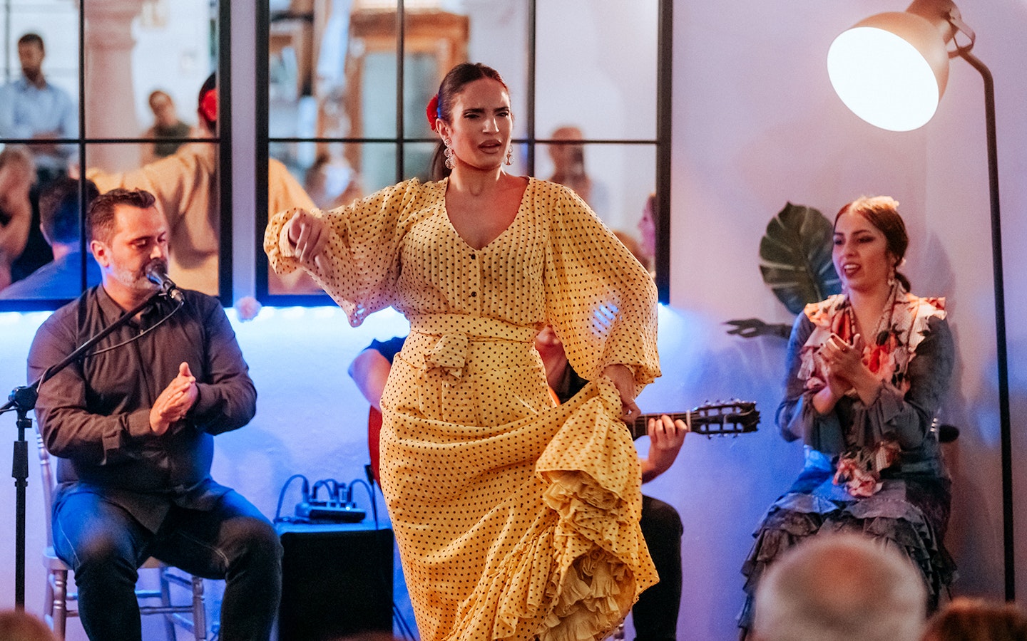 Flamenco dancer performing at Taberna Doble de Cepa with musicians in the background.
