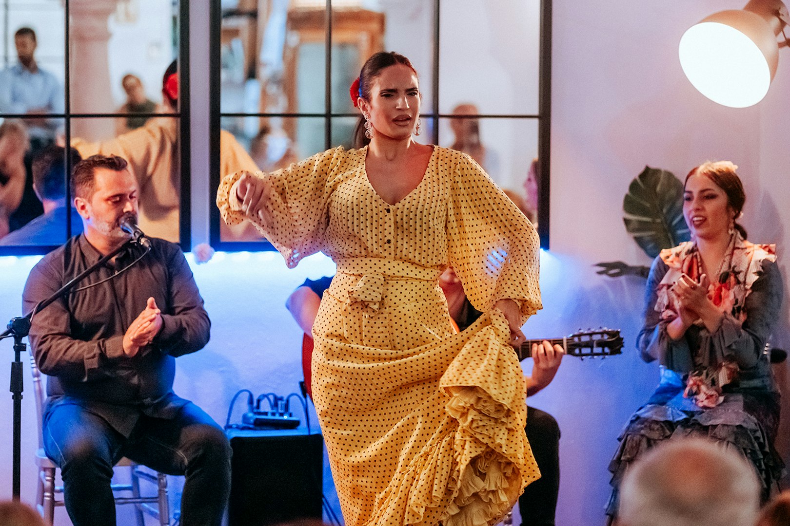 Flamenco dancer performing at Taberna Doble de Cepa with musicians in the background.