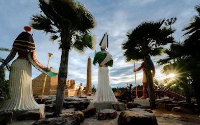 Nong Nooch Tropical Garden statues and obelisk with sunset in Pattaya, Thailand.