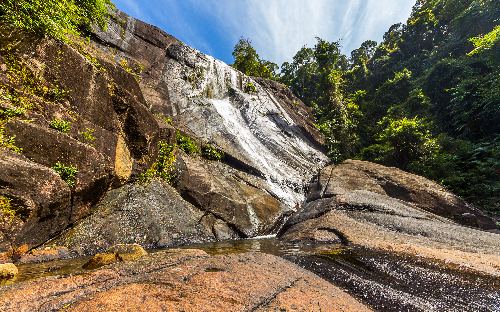Telaga Tujuh waterfall cascading through lush rainforest in Langkawi, Malaysia.