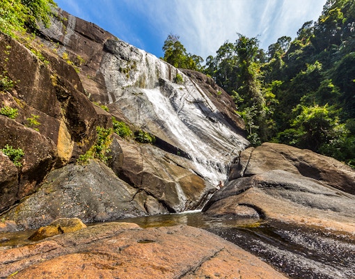 Telaga Tujuh waterfall cascading through lush rainforest in Langkawi, Malaysia.