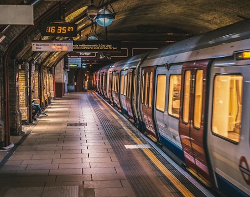 London Underground train at a station platform with signage for Bakerloo and Jubilee lines.