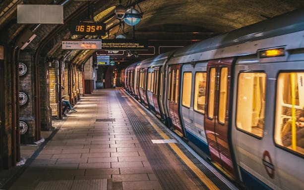 London Underground train at a station platform with signage for Bakerloo and Jubilee lines.