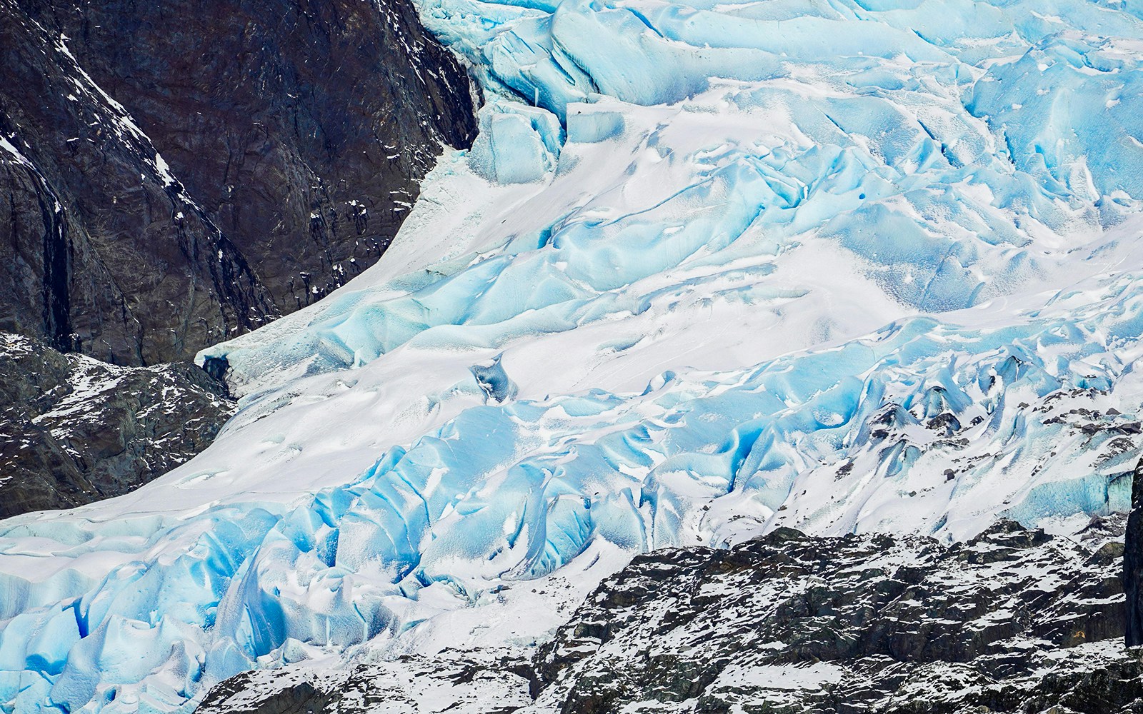 Mendenhall Glacier's icy blue surface and rocky terrain in Juneau, Alaska.