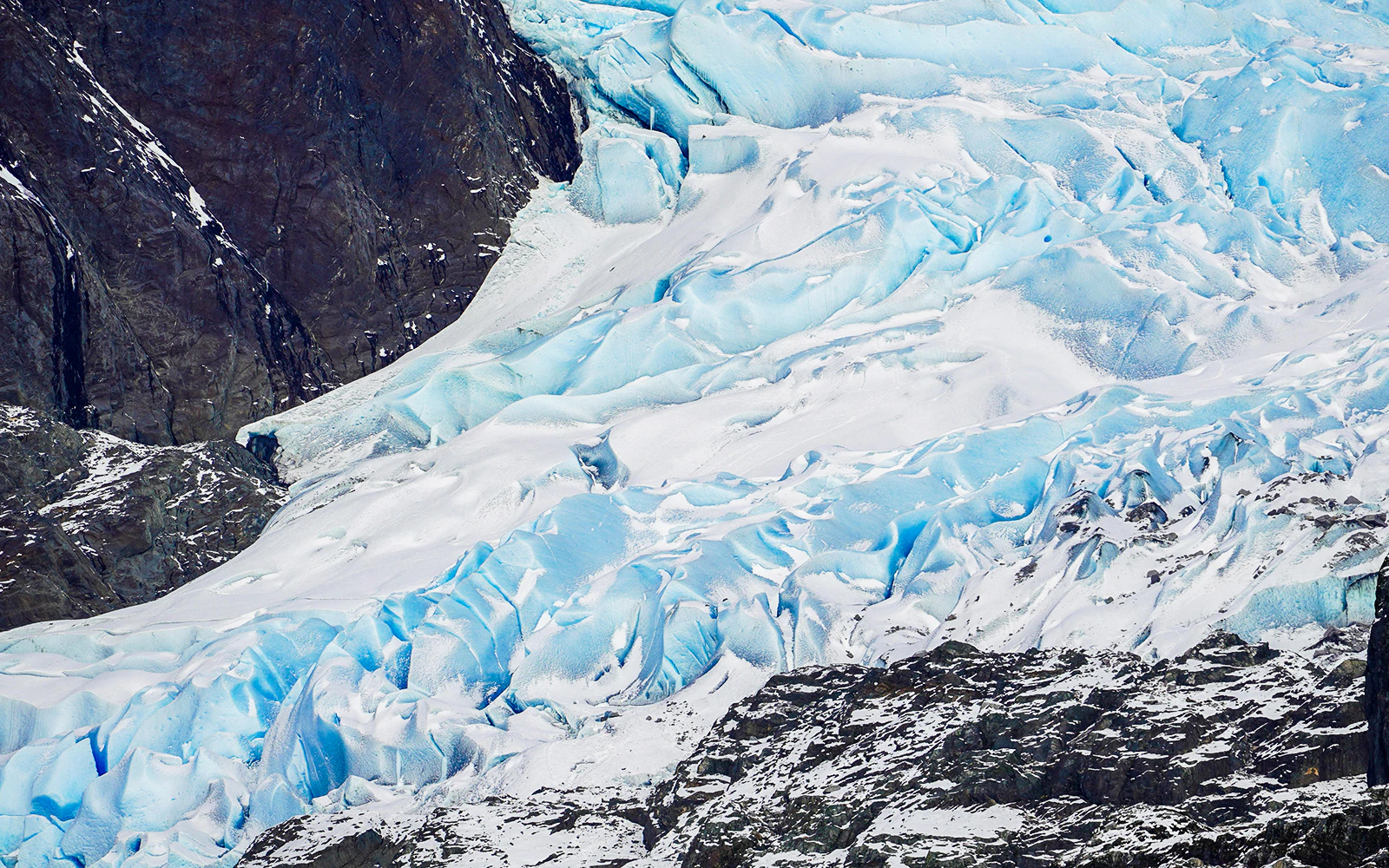 Mendenhall Glacier's icy blue surface and rocky terrain in Juneau, Alaska.