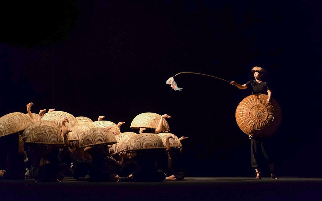 Performers with baskets at A O Show circus in Vietnam.