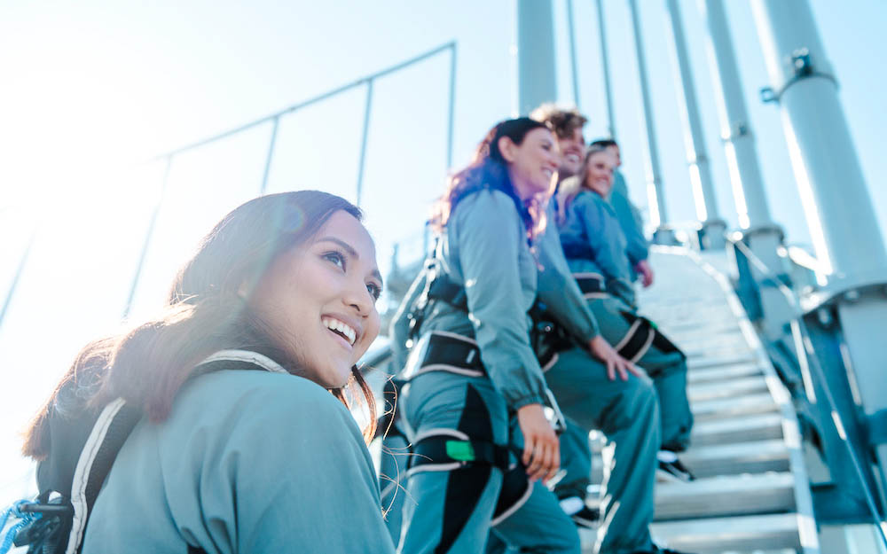 Climbers ascending Skypoint on the Gold Coast, Australia, wearing safety gear.