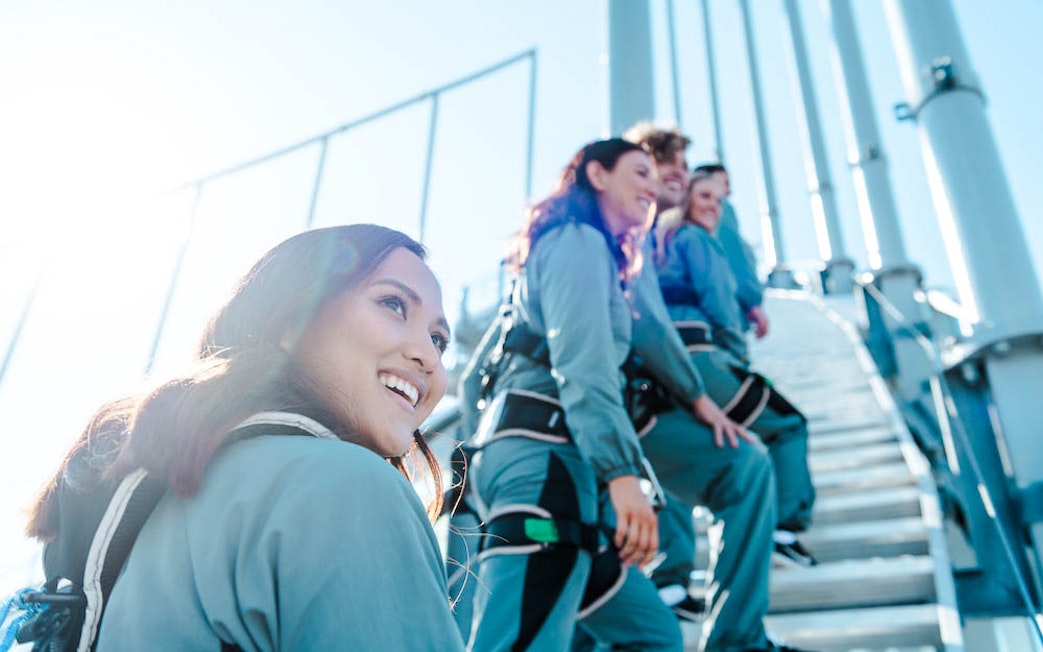 Climbers ascending Skypoint on the Gold Coast, Australia, wearing safety gear.