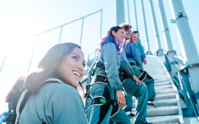 Climbers ascending Skypoint on the Gold Coast, Australia, wearing safety gear.