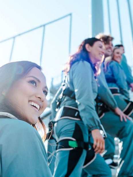 Climbers ascending Skypoint on the Gold Coast, Australia, wearing safety gear.