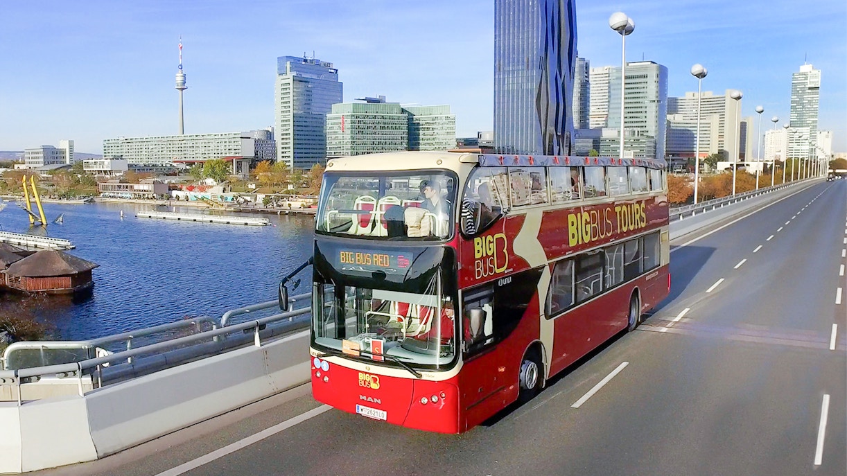 Tourists on Vienna Hop-On Hop-Off Bus Tour with Ferris Wheel and Danube River Cruise in view