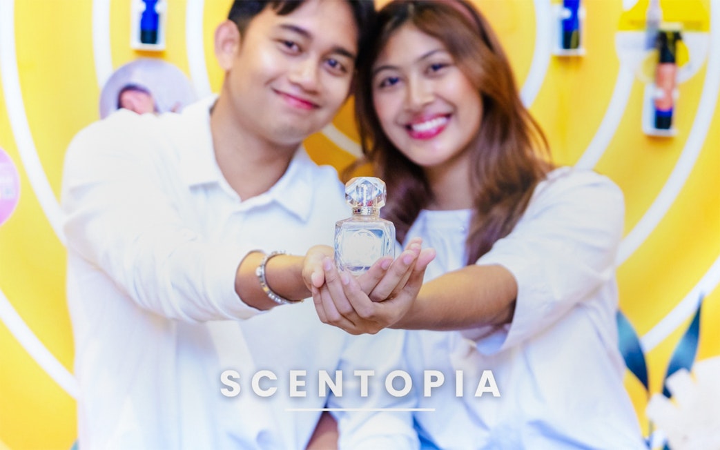 Couple holding perfume bottle at Scentopia Sentosa Singapore.