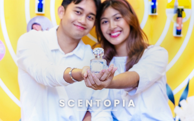 Couple holding perfume bottle at Scentopia Sentosa Singapore.