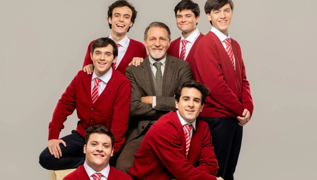 Group of students in red sweaters with a teacher, related to Dead Poets Society.