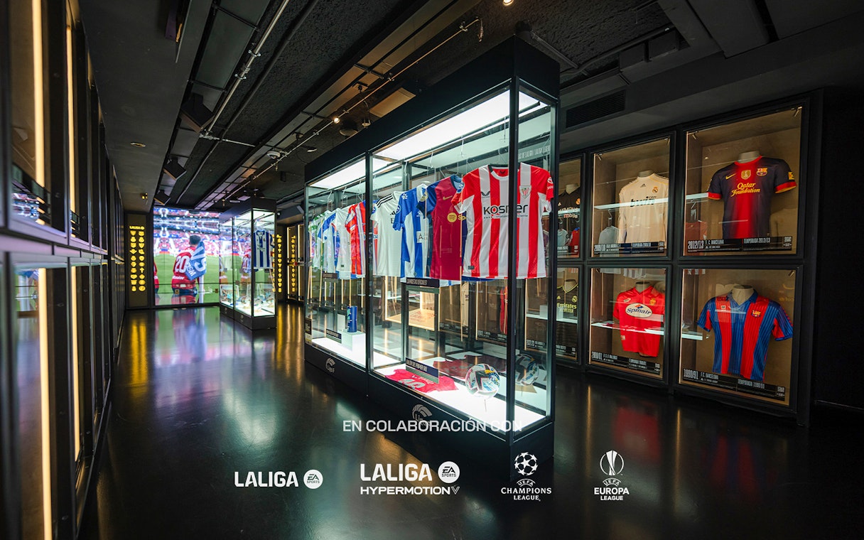 Football jerseys displayed in glass cases at the Legends of Football Museum.