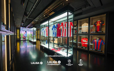 Football jerseys displayed in glass cases at the Legends of Football Museum.