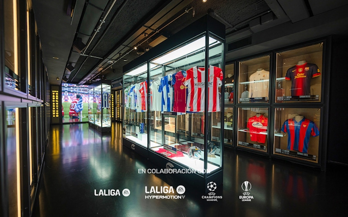 Football jerseys displayed in glass cases at the Legends of Football Museum.