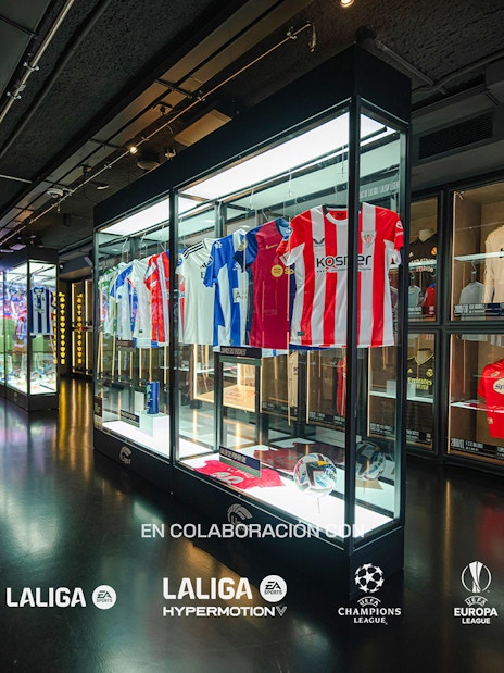 Football jerseys displayed in glass cases at the Legends of Football Museum.